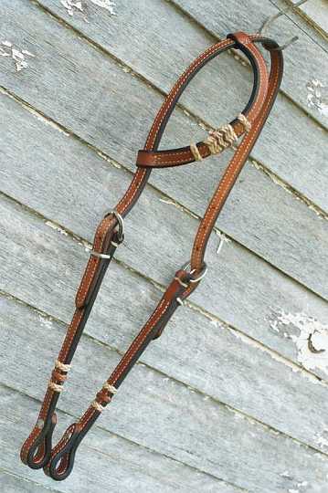 025_22-1.jpg - Sliding One Ear Bridle - with rawhide Knots ~ Natural with black edge.
Dressed with Stainless Light Heel Buckles, keepers & screws.