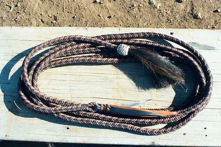 009_6-1.jpg - 12 plait parachute cord mecate with horse hair and rawhide pineapple knot with kangaroo hide interweaves.