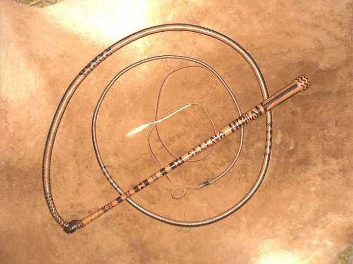 Oct03_02-1.jpg - This is a 32 x24 plait 6ft stock whip that was entered in the " Dame Mary Outback Craft Awards" and recieved a Highly commended award in 2001.with name plaiting "HAPPY 21st" on one side and "SELENA" on the other.